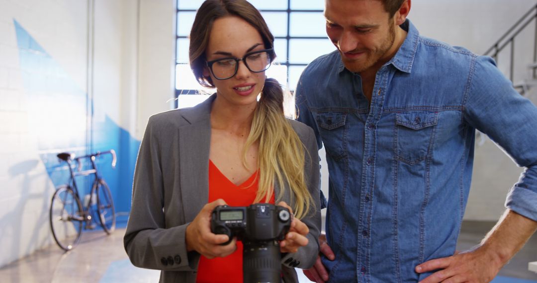 Young Photographer Showing Work to Colleague - Free Images, Stock Photos and Pictures on Pikwizard.com