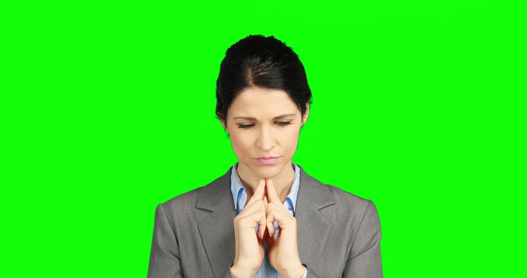 A pensive businesswoman contemplates a decision against a green screen with copy space. - Free Images, Stock Photos and Pictures on Pikwizard.com