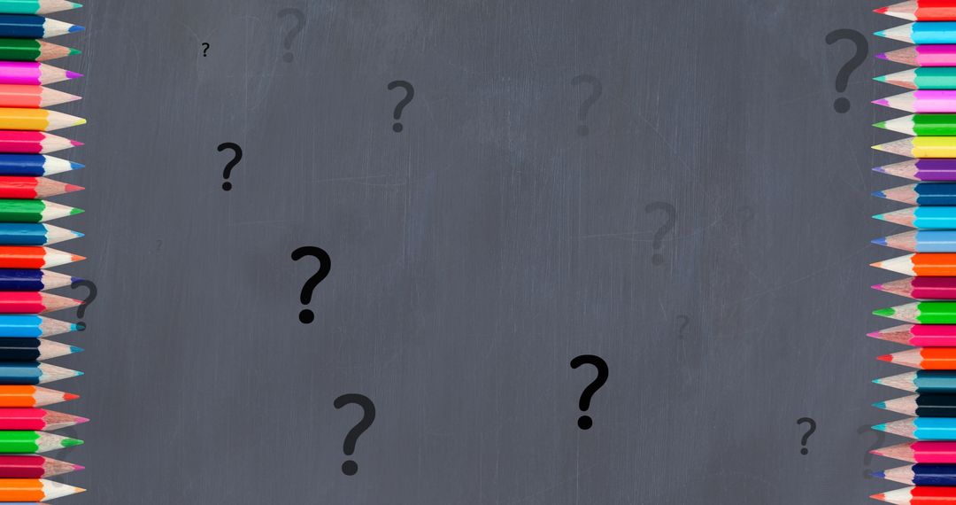 Colorful Crayons Framing Question Marks on Chalkboard