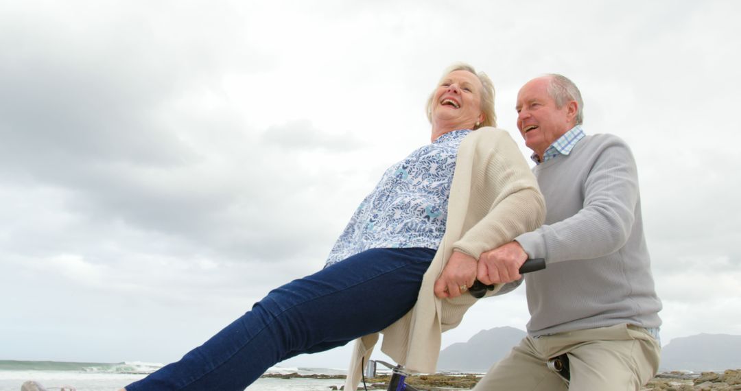 Happy Senior Couple Enjoying Outdoors on Seesaw by Beach - Free Images, Stock Photos and Pictures on Pikwizard.com