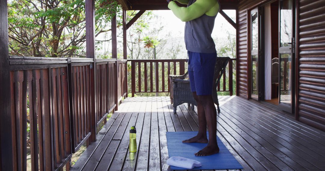 Senior Man Practicing Yoga on Cabin Deck