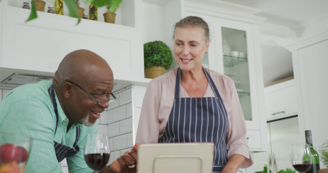 Senior Couple Cooking Together in Kitchen Using Tablet