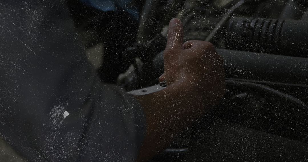 Mechanic Tightening Hoses in Engine Bay with Socket Wrench