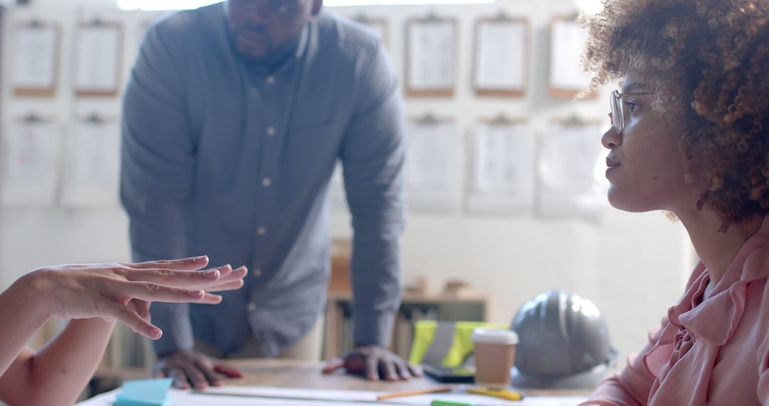 Diverse Architects Collaborating on Project Blueprint