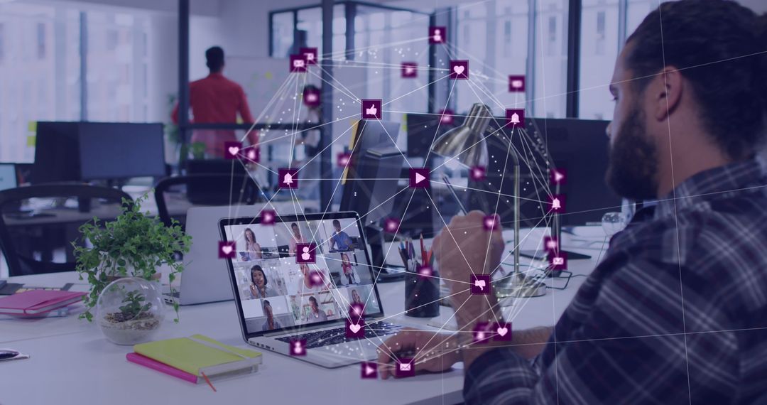 Man Using Laptop with Social Media Icons Floating in Office - Free Images, Stock Photos and Pictures on Pikwizard.com