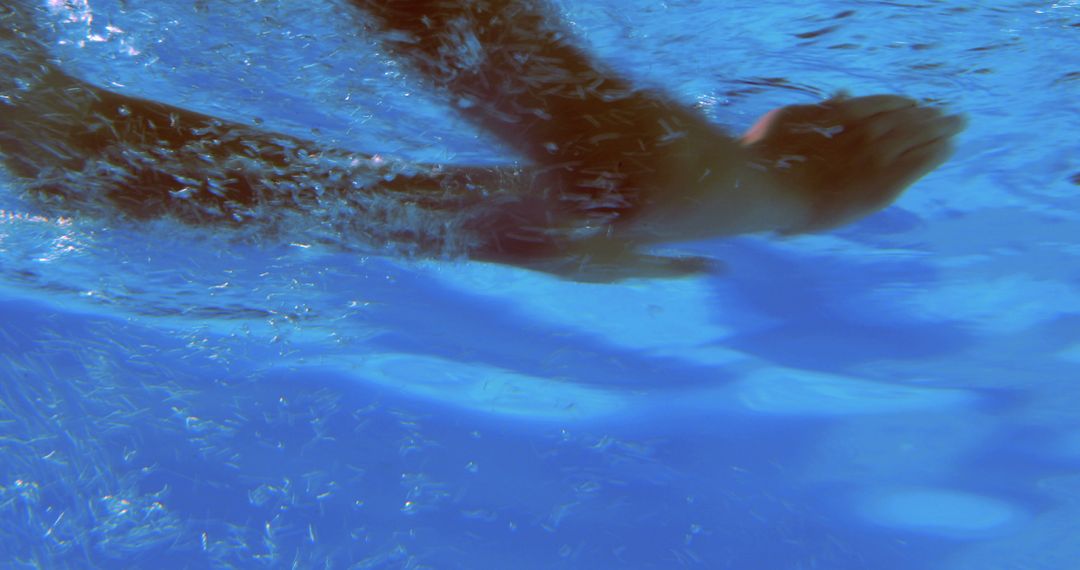 Underwater View of Hands Swimming in Clear Blue Pool - Free Images, Stock Photos and Pictures on Pikwizard.com