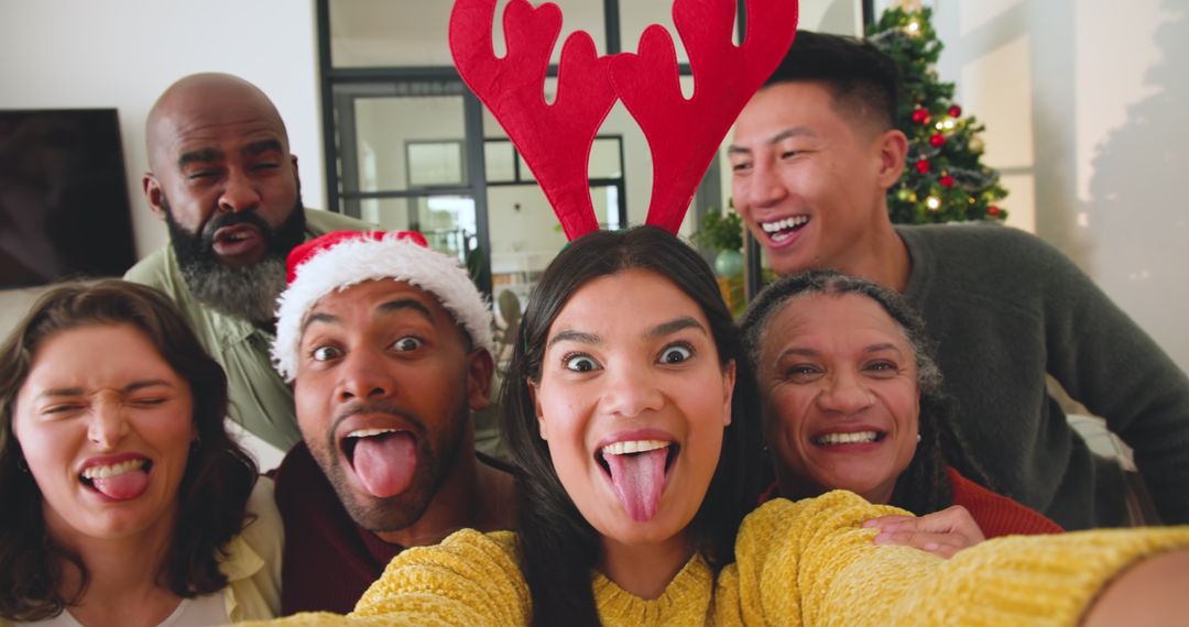 Diverse Friends Celebrating at Holiday Gathering with Fun Playful Selfie