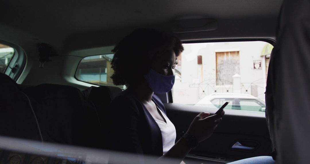 Woman Wearing Face Mask Sitting in Backseat Using Smartphone - Free Images, Stock Photos and Pictures on Pikwizard.com