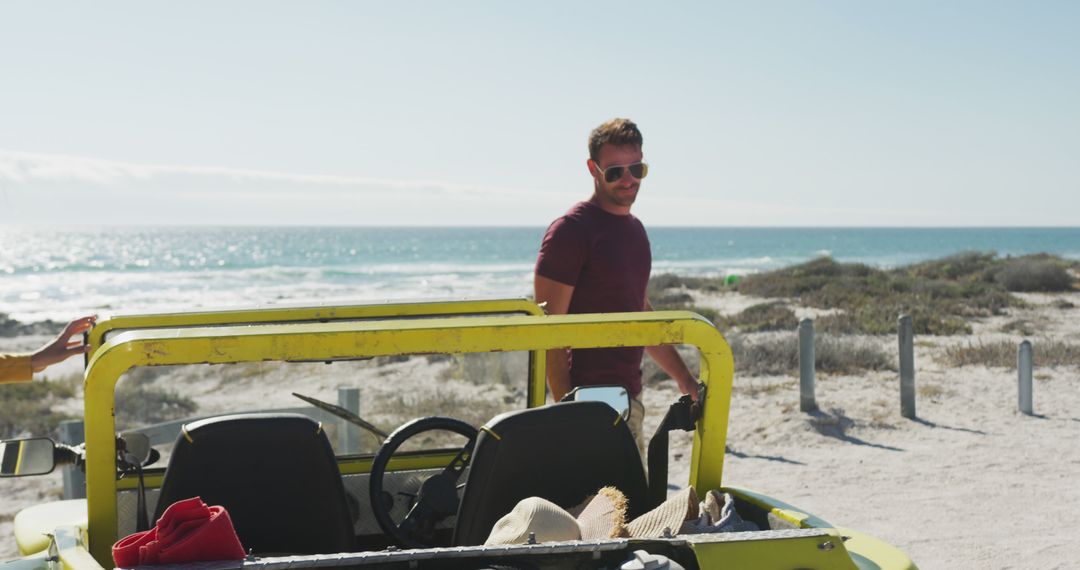 Smiling Man Standing Near Yellow Beach Buggy by Ocean Marina - Free Images, Stock Photos and Pictures on Pikwizard.com