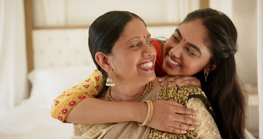 Smiling Mother and Daughter Embracing in Warm, Joyful Bonding Moment