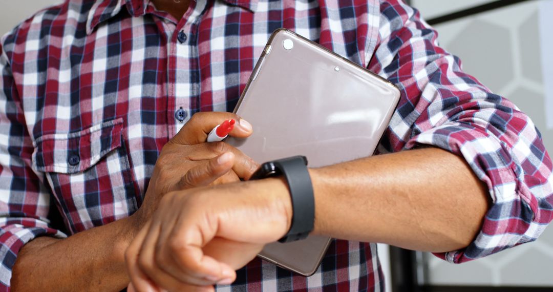 Man Holding Tablet Checking Smartwatch for Time - Free Images, Stock Photos and Pictures on Pikwizard.com