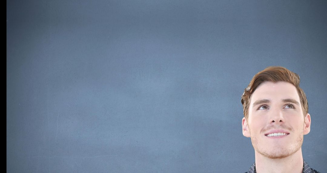 Man Smiling Thoughtfully Against Minimalist Background