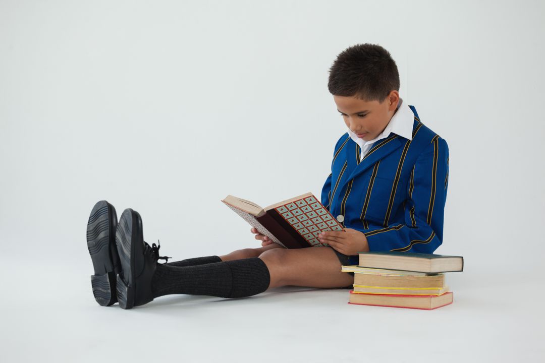 Schoolboy reading book on white background - Free Images, Stock Photos and Pictures on Pikwizard.com