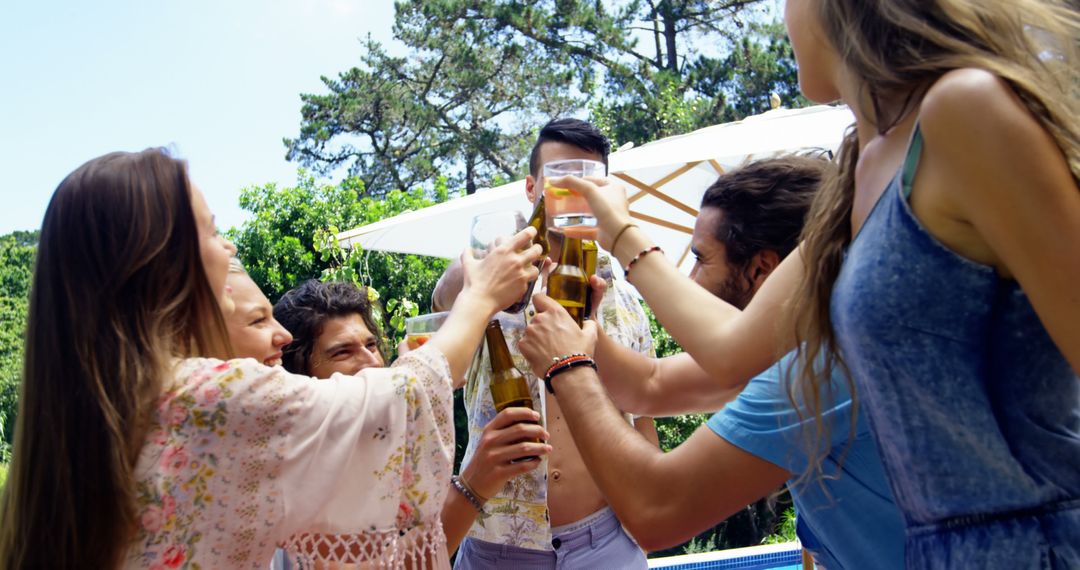 Young Adults Enjoying Summer Outdoor Gathering Toasting Drinks - Free Images, Stock Photos and Pictures on Pikwizard.com