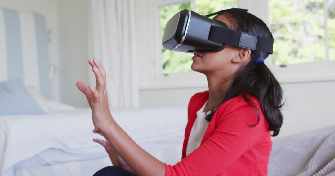 Girl Experiencing Virtual Reality with VR Headset in Modern Home - Free Images, Stock Photos and Pictures on Pikwizard.com