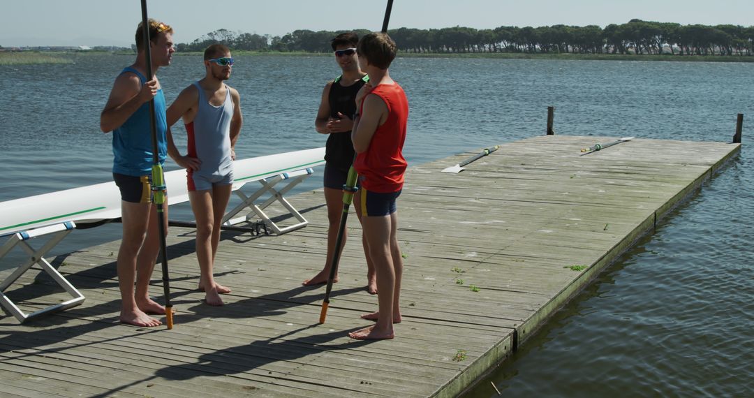 Team of Young Rowers Discussing Strategy on Lake Dock - Free Images, Stock Photos and Pictures on Pikwizard.com