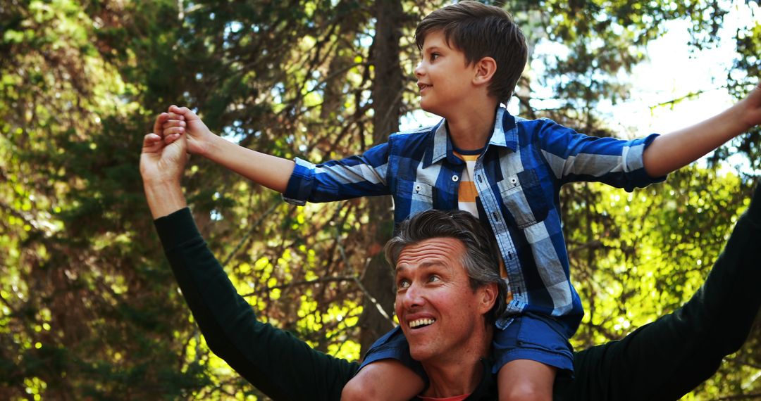 Father Carrying Son on Shoulders in Forest - Free Images, Stock Photos and Pictures on Pikwizard.com