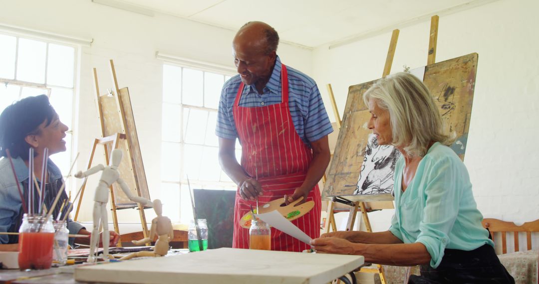 Diverse Group Engaged in Art Class with Instructor
