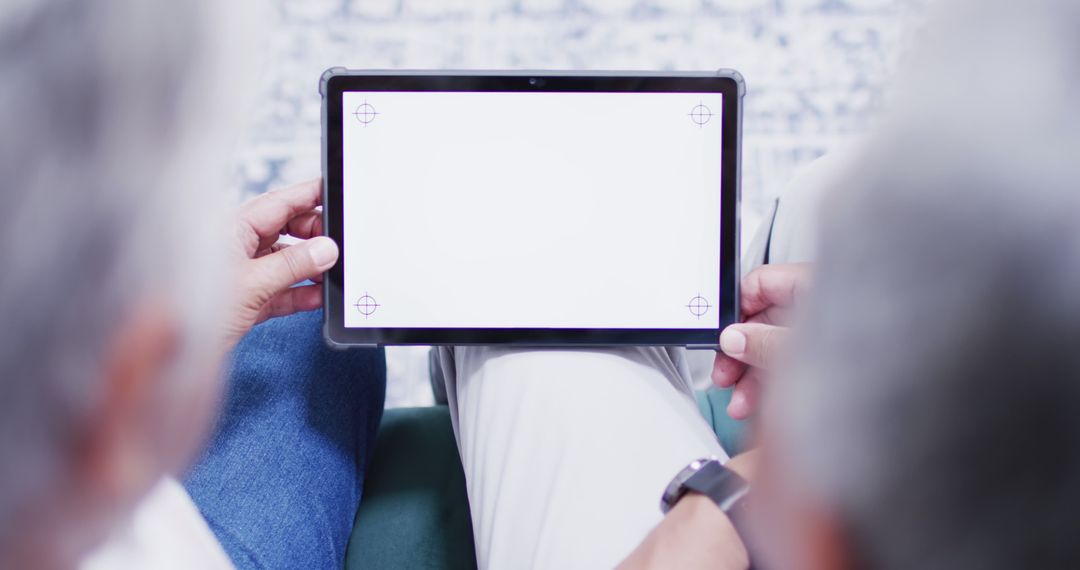 Senior Couple Using Tablet for Video Call at Home