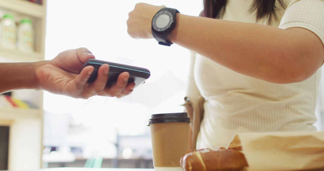 Woman Paying With Smartwatch at Cafe