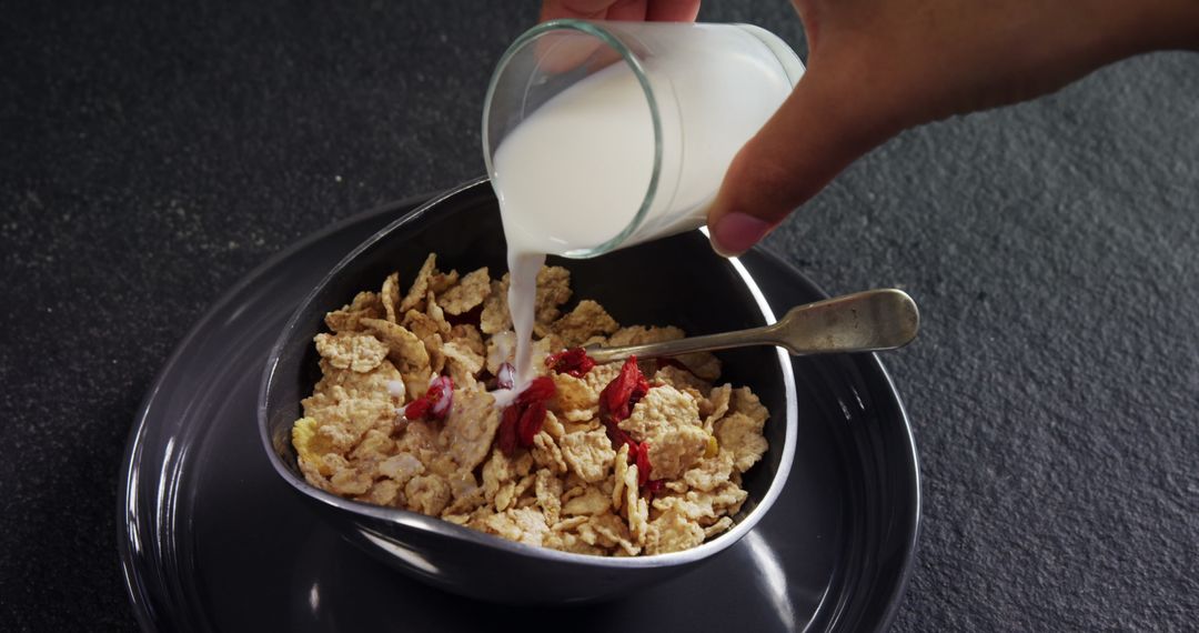 Pouring Milk into Bowl of Cornflakes with Berries - Free Images, Stock Photos and Pictures on Pikwizard.com