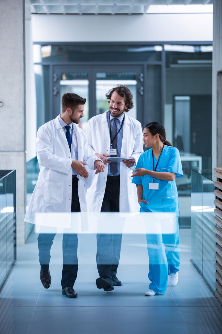 Medical Team Discussing Patient Care in Hospital Corridor