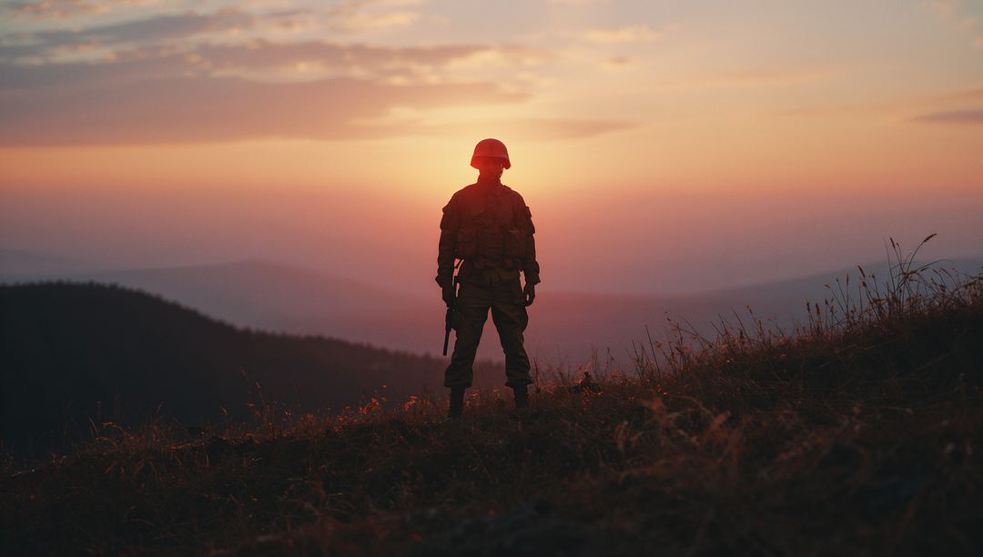 Soldier Standing on Hilltop at Sunset Overlooking Dramatic Horizon