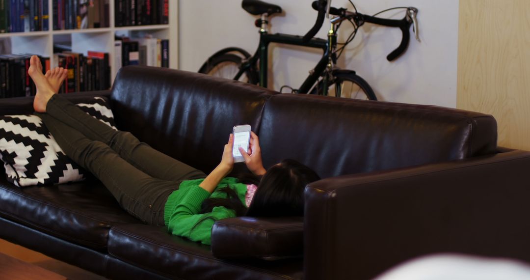 Woman Relaxing on Sofa Using Smartphone at Home - Free Images, Stock Photos and Pictures on Pikwizard.com