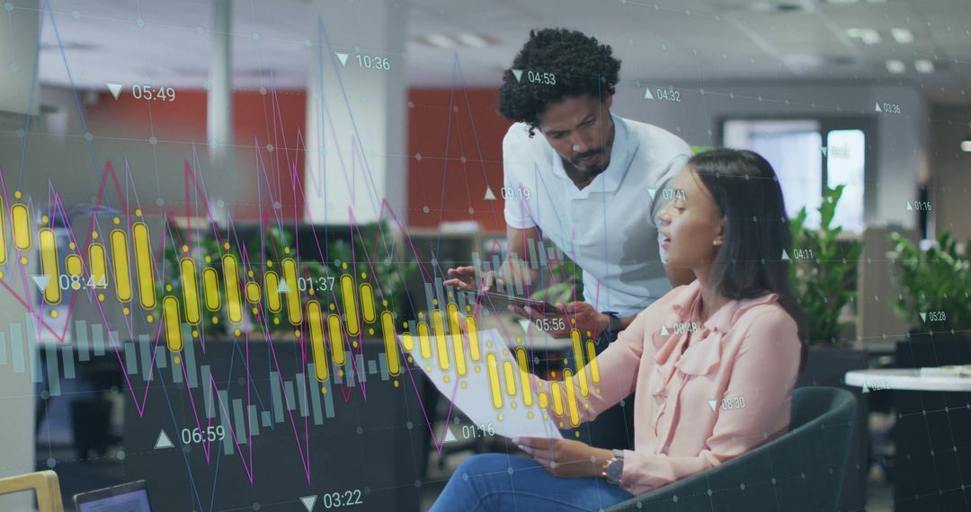 Colleagues Analyzing Data Charts in Modern Office Environment