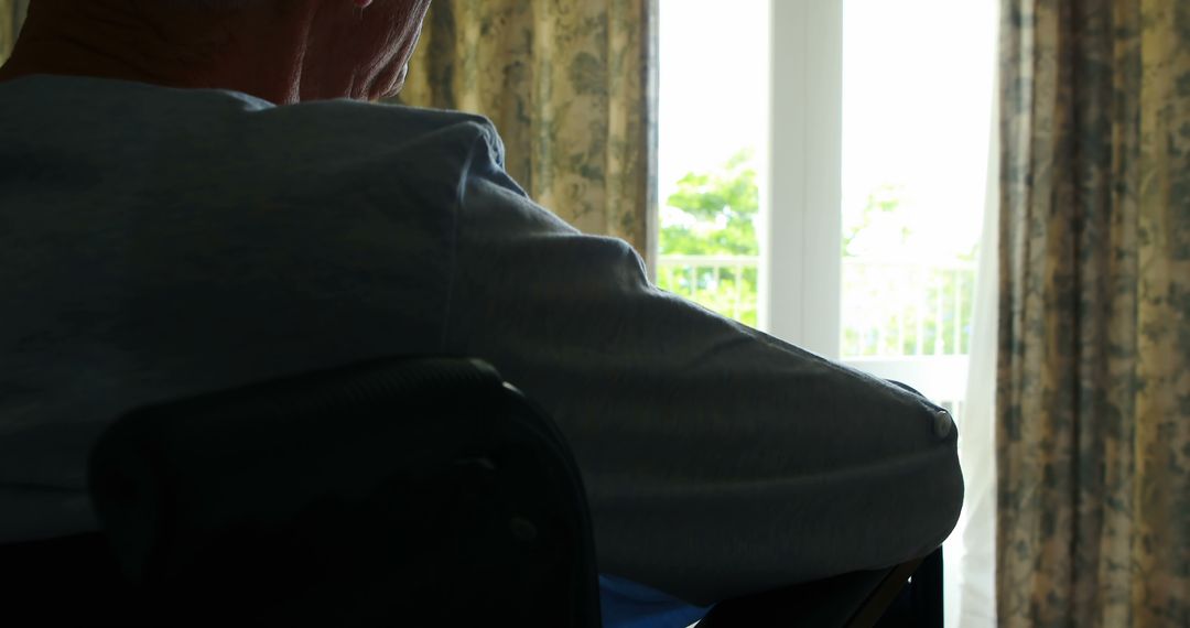 Solitary Elderly Person in Wheelchair Facing Balcony Window - Free Images, Stock Photos and Pictures on Pikwizard.com