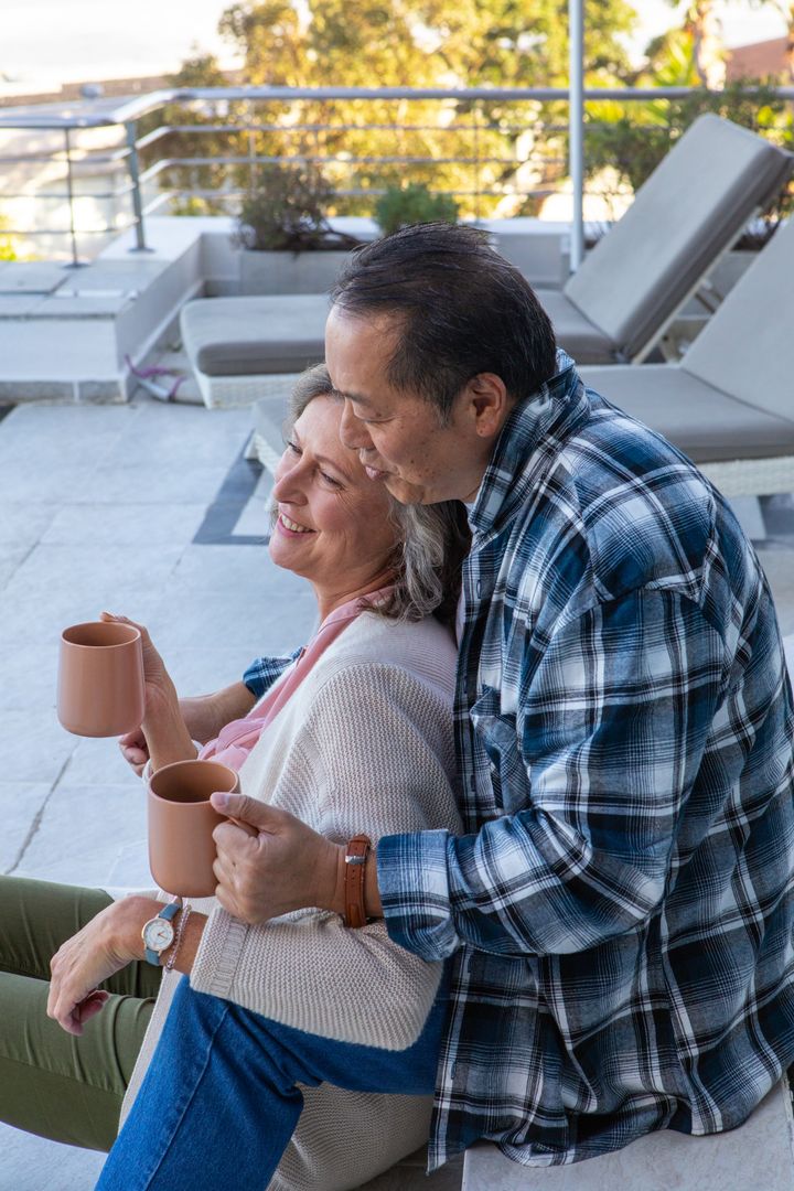 Diverse Couple Sharing Coffee on Rooftop Terrace