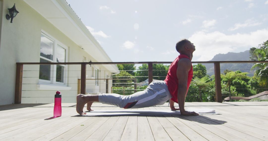 Focused Man Practicing Yoga on Outdoor Terrace