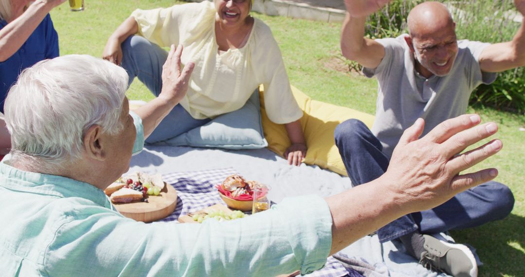 Senior Friends Enjoying Picnic Outdoors on Sunny Day - Free Images, Stock Photos and Pictures on Pikwizard.com