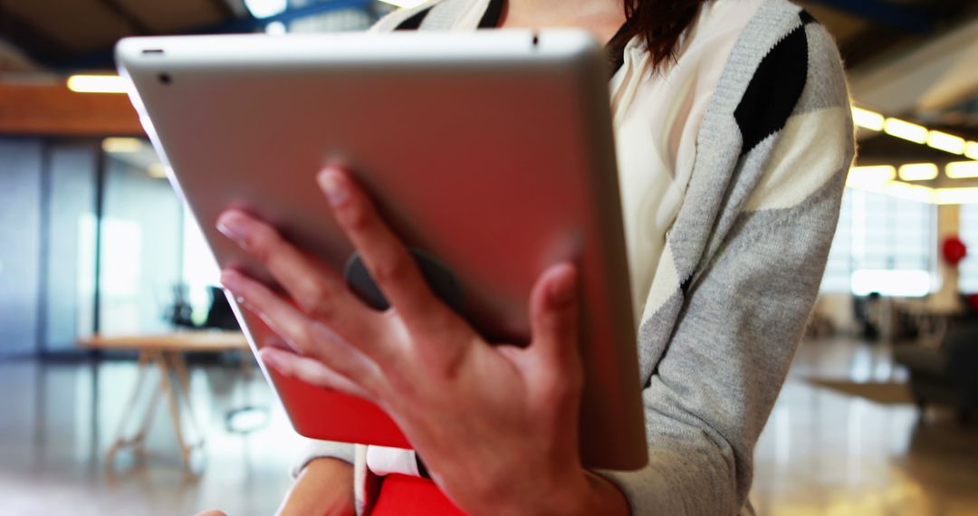 Businesswoman Holding Tablet Computer in Modern Office - Free Images, Stock Photos and Pictures on Pikwizard.com