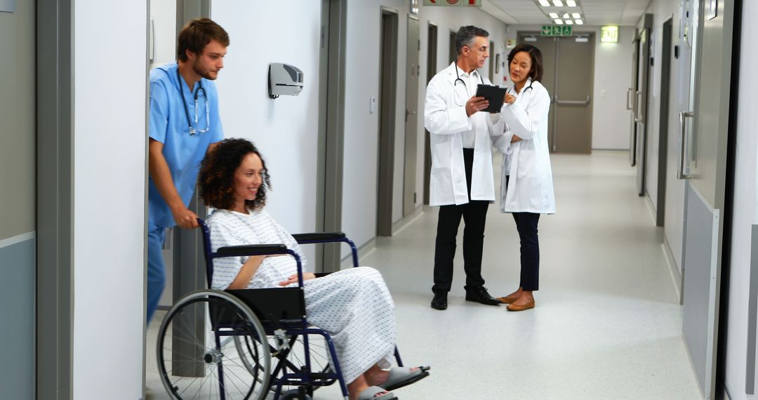 Medical Professionals Assisting Patient in Hospital Corridor - Free Images, Stock Photos and Pictures on Pikwizard.com