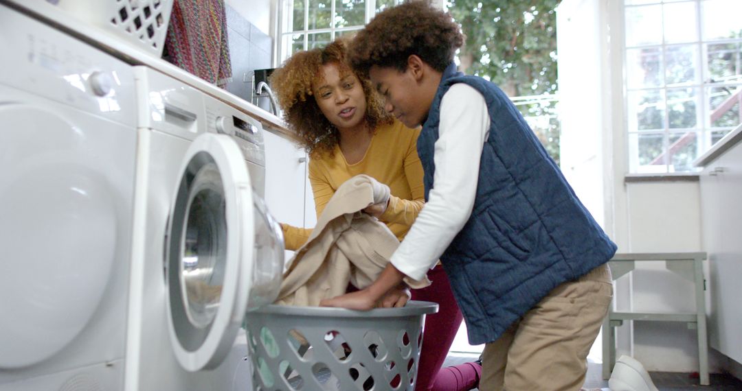 Mother and Son Doing Laundry Together at Home - Free Images, Stock Photos and Pictures on Pikwizard.com