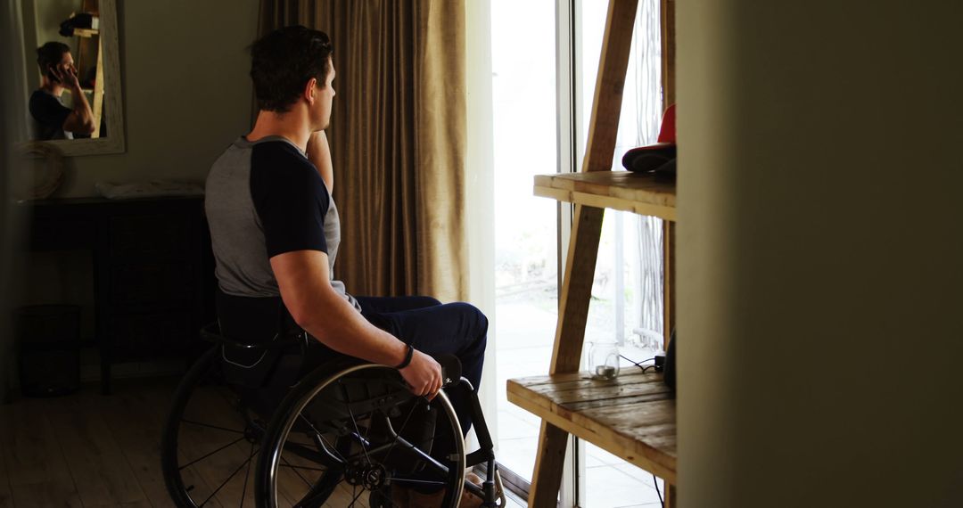 Man in Wheelchair Looking Out Window at Home - Free Images, Stock Photos and Pictures on Pikwizard.com