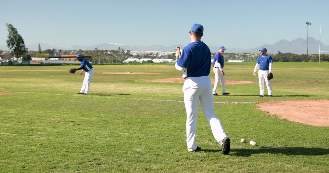 Baseball Team Practicing on Sunny Field in Blue Uniforms