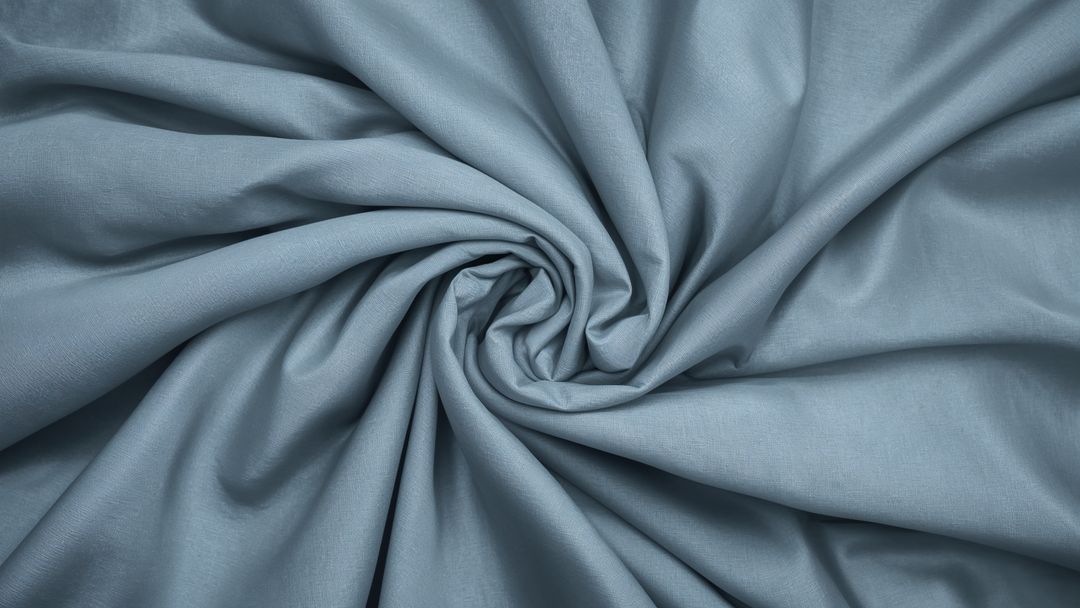 Elegant Spiral Pattern on Light Blue Fabric
