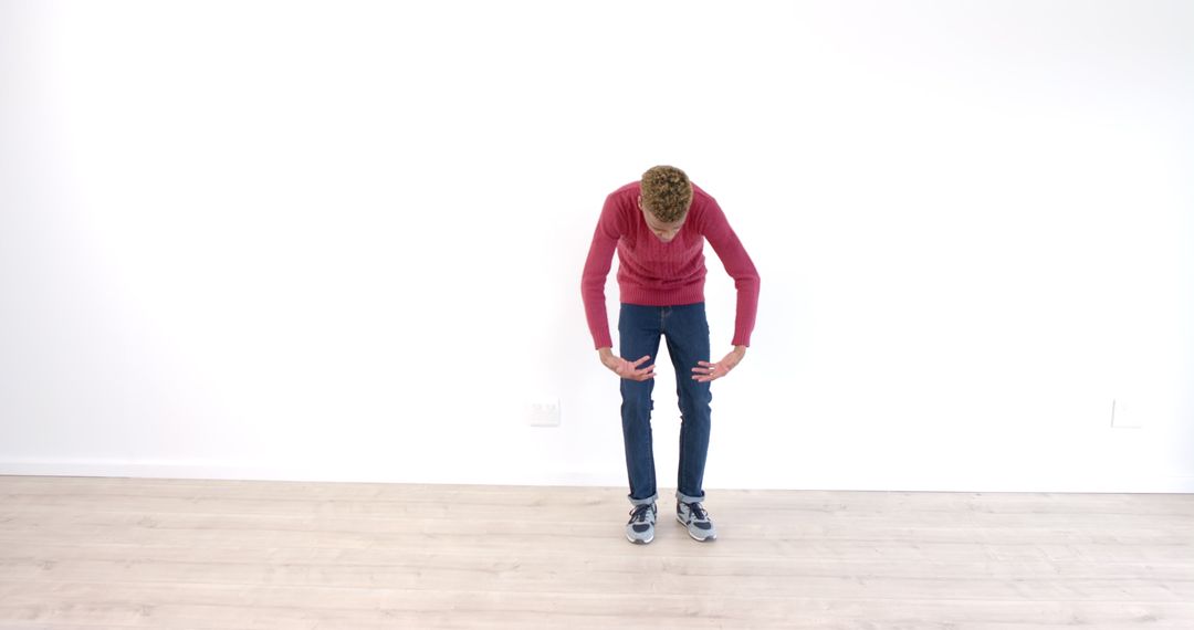 Young Man Tying Shoelaces for Exercise in Bright Room