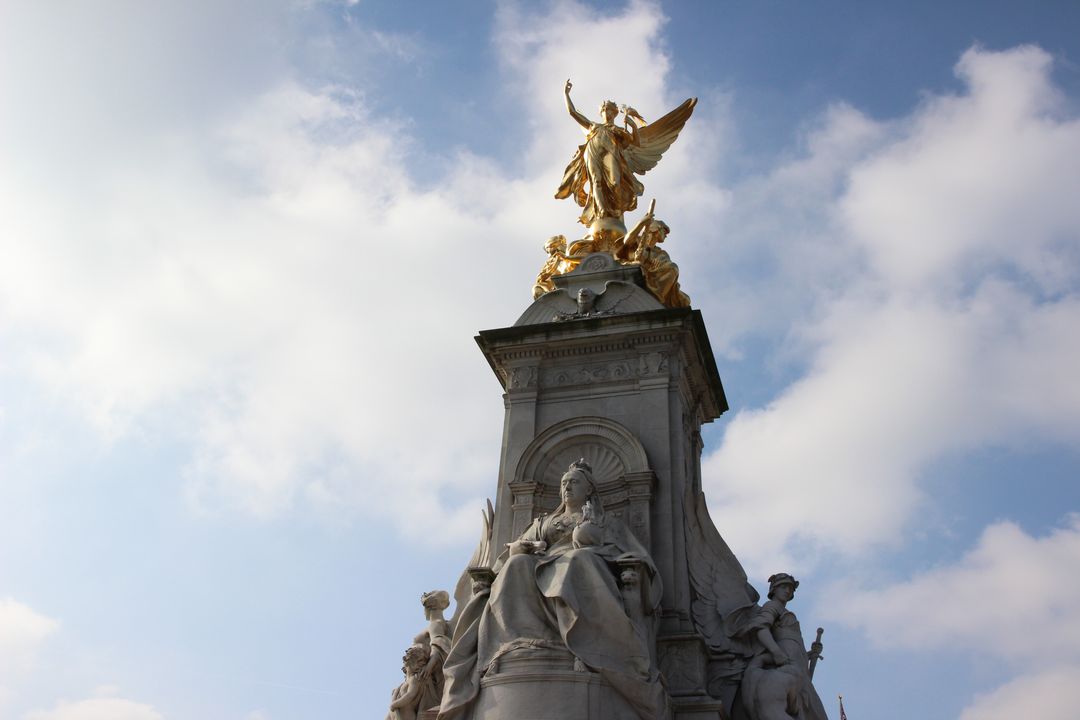 Golden Statue Atop Monument on a Clear Day