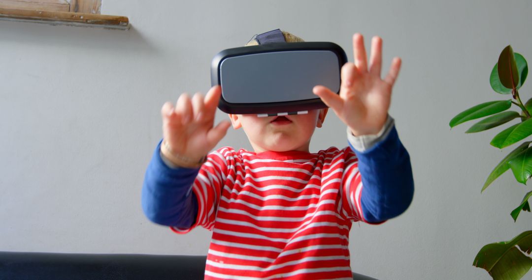 Young Boy Engaging with Virtual Reality While Sitting on Sofa
