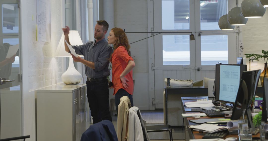 Colleagues Collaborating by Whiteboard in Modern Office