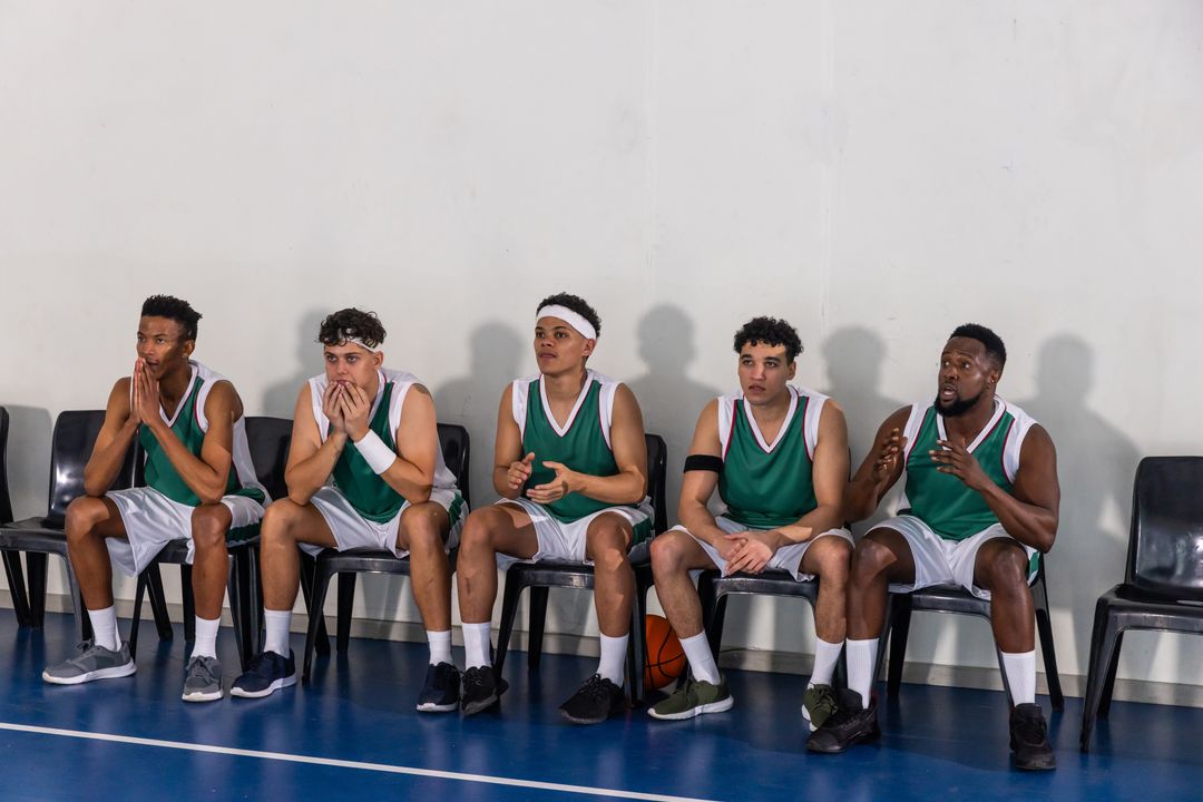 Basketball Team Sitting on Sidelines Awaiting Gameplay