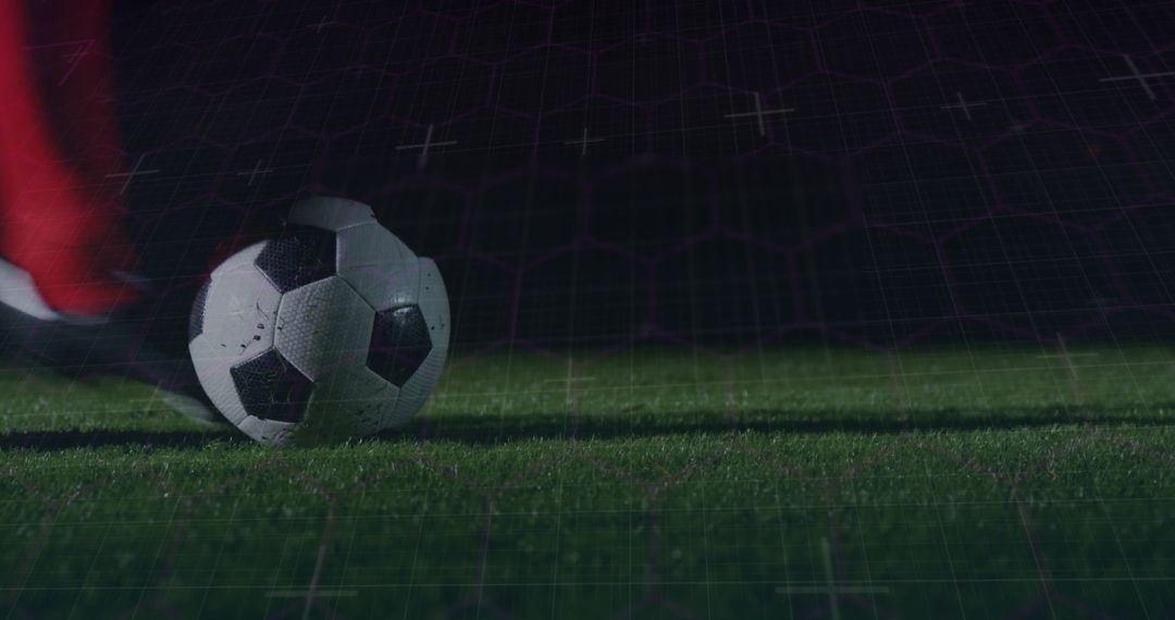 Soccer Ball Beneath Cleat with Digital Grid and Night Backdrop