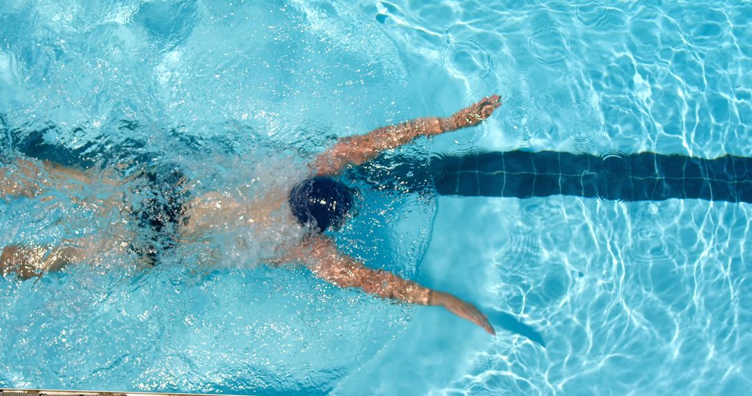 Swimmer Performing Freestyle Stroke in Pool - Free Images, Stock Photos and Pictures on Pikwizard.com