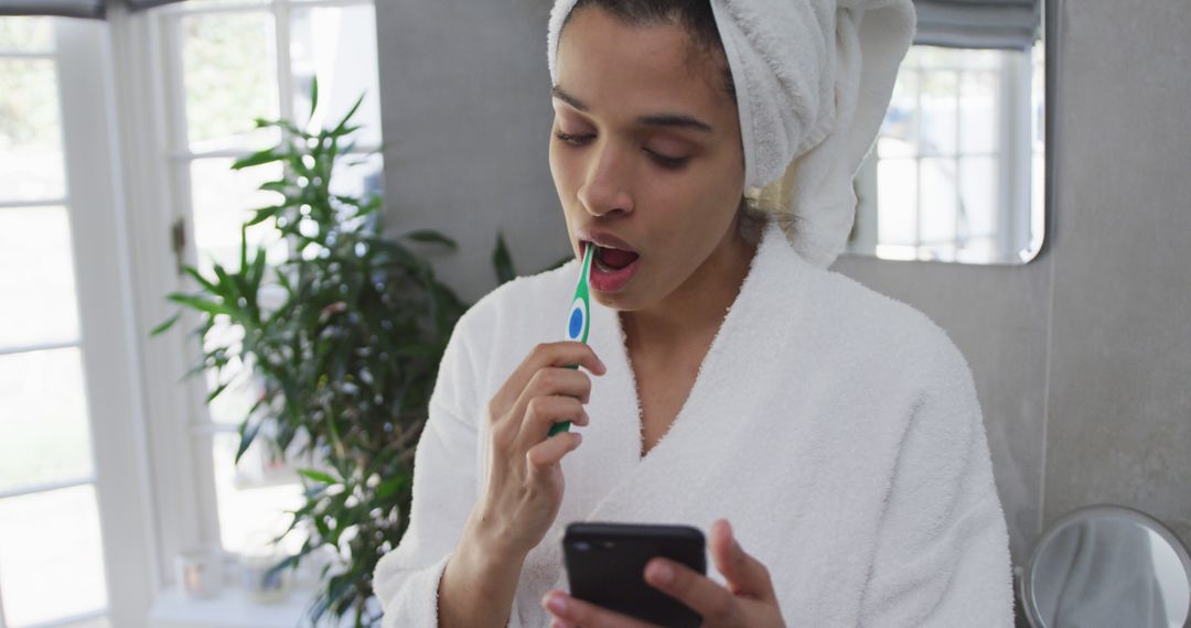 Woman Multitasking in Bathroom, Brushing Teeth While Using Smartphone - Free Images, Stock Photos and Pictures on Pikwizard.com