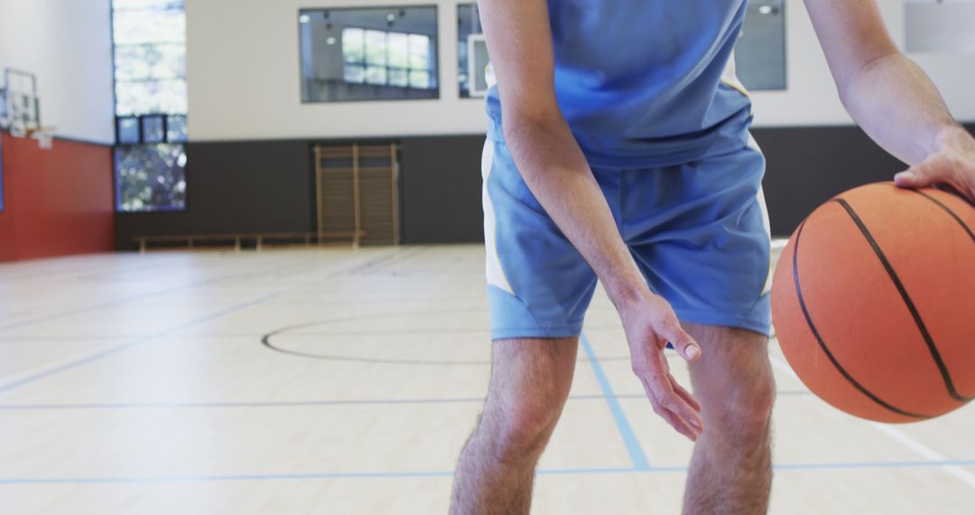 Close-up of Male Basketball Player Dribbling Ball in Empty Gym - Free Images, Stock Photos and Pictures on Pikwizard.com