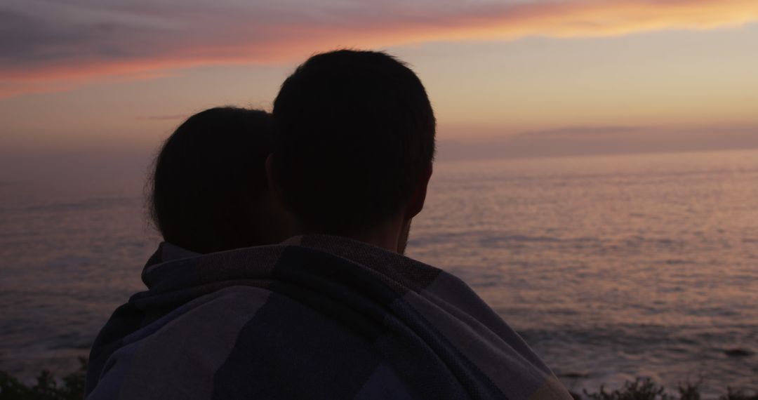 Couple Embracing During Sunset by the Ocean - Free Images, Stock Photos and Pictures on Pikwizard.com