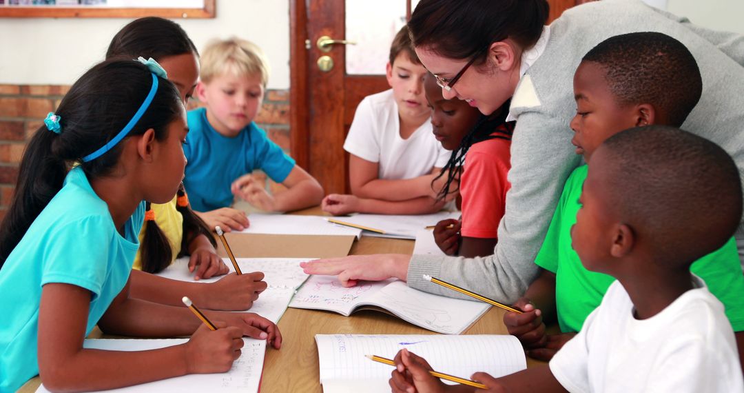 Teacher Helping Diverse Students During Classroom Activity - Free Images, Stock Photos and Pictures on Pikwizard.com